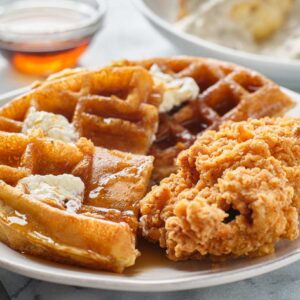 fried chicken and waffles breakfast with syrup