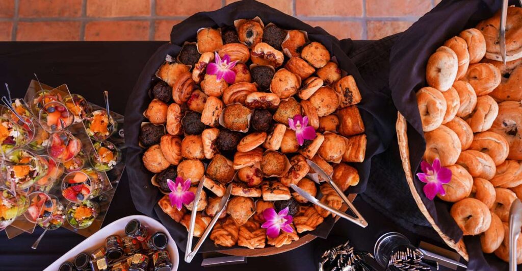 Pastries on display with black table cloth and high-end presentation