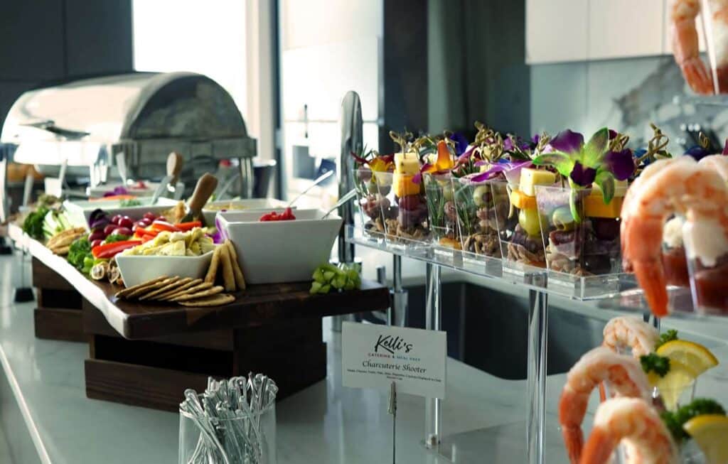 Premium skybox venue full service catering spread by Kelli's Catering & Events for corporate and VIP events