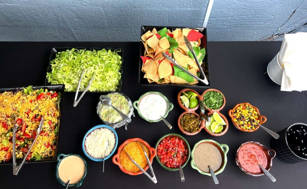 Colorful taco bar interactive food station catered by Kelli's Catering & Events for private and corporate events